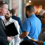 A recruiter speaks with a candidate at the Mega Job Fair held June 23, 2022, in Sunrise, Fla. Organizations tend to hire candidates who they have the strongest “gut feeling about,” the Textio report found.