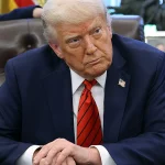 President Donald Trump speaks to reporters in the Oval Office at the White House on April 17, 2025, in Washington, D.C. Trump directed federal agencies to end disparate-impact liability under civil rights laws.