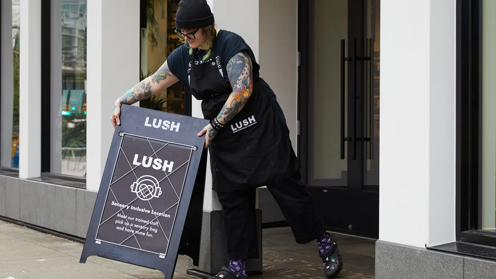 A Lush employee puts out a sign about the KultureCity pilot program. The latter organization, which supports people with sensory disabilities, partnered with Lush as apart of Autism Awareness Month.