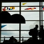 Passengers move through Ronald Reagan Washington National Airport on May 23, 2025, in Arlington, Va. For yet another year, the number of employees who say they disconnect from work completely while on vacation has declined.