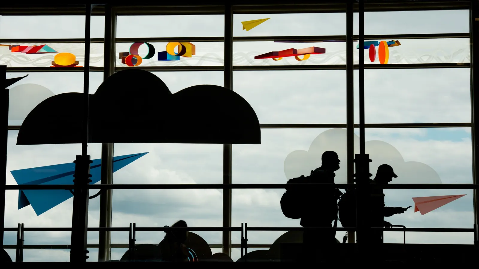 Passengers move through Ronald Reagan Washington National Airport on May 23, 2025, in Arlington, Va. For yet another year, the number of employees who say they disconnect from work completely while on vacation has declined.